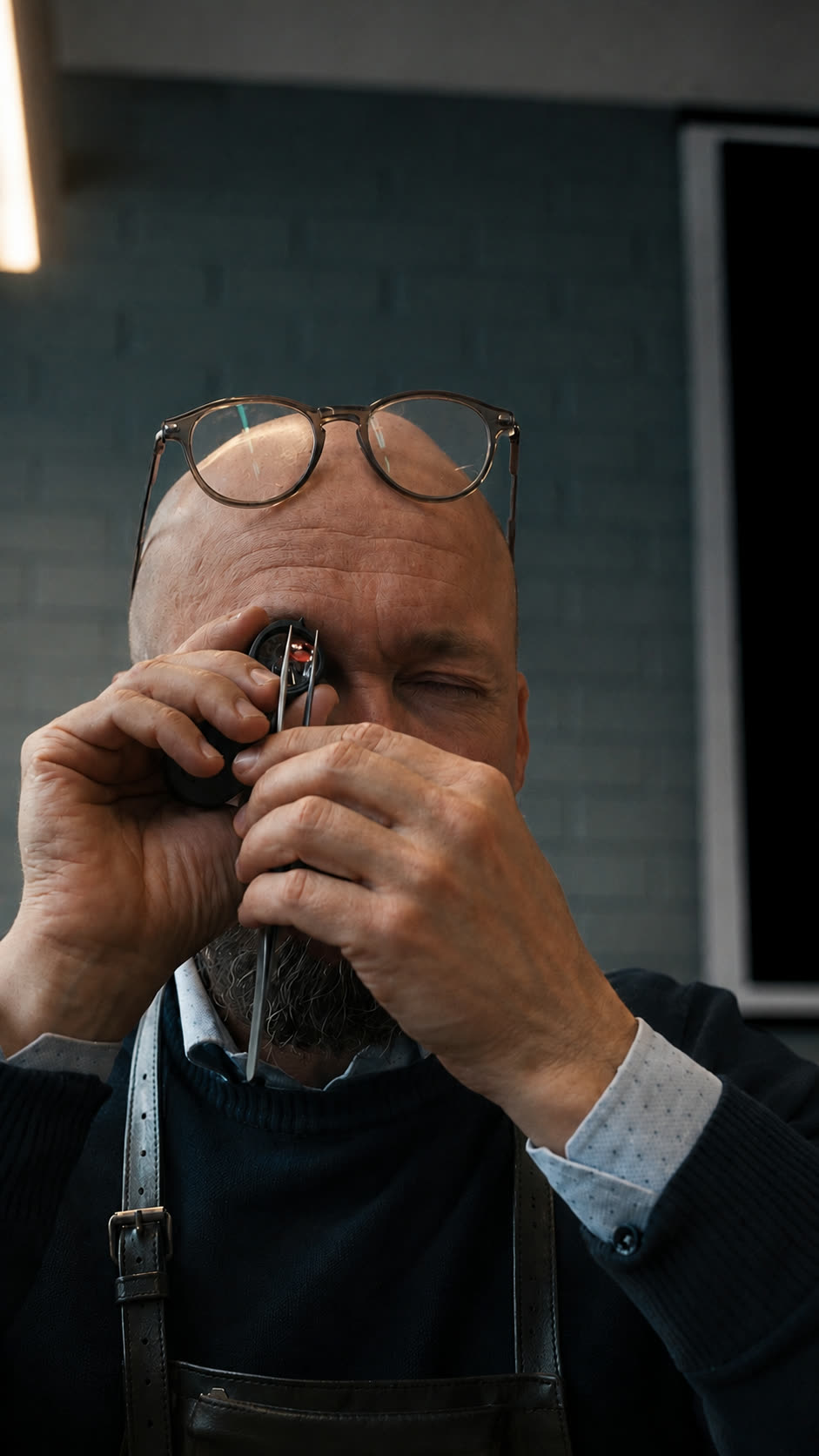 The Kulmala goldsmith examining a piece through his loupe